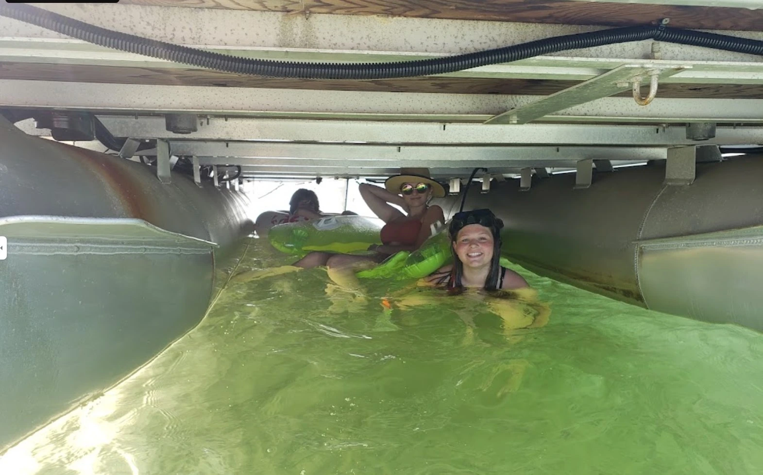 customers in water under the boat during boat rental from port st. joe